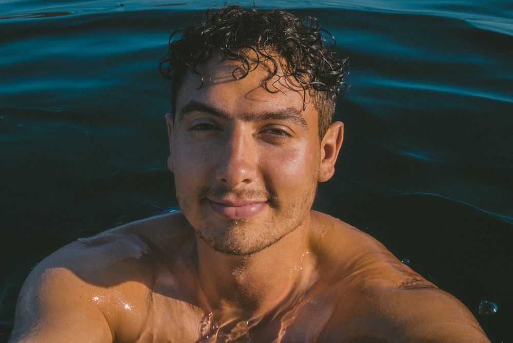 man taking selfie on body of water