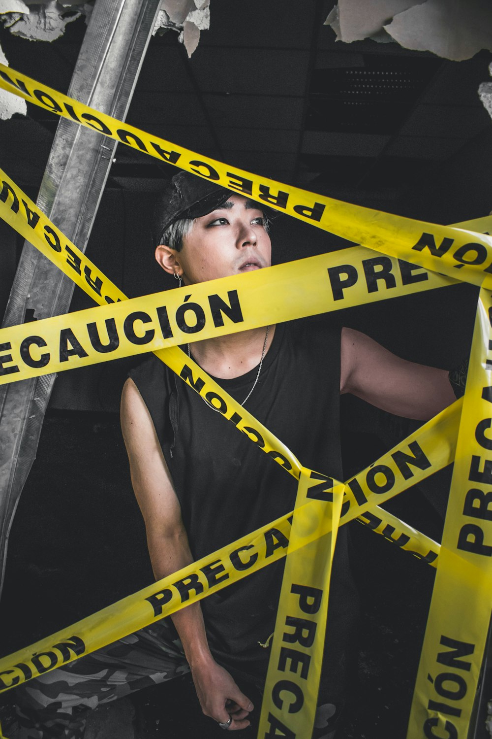 man in black tank top standing near precaucion straps