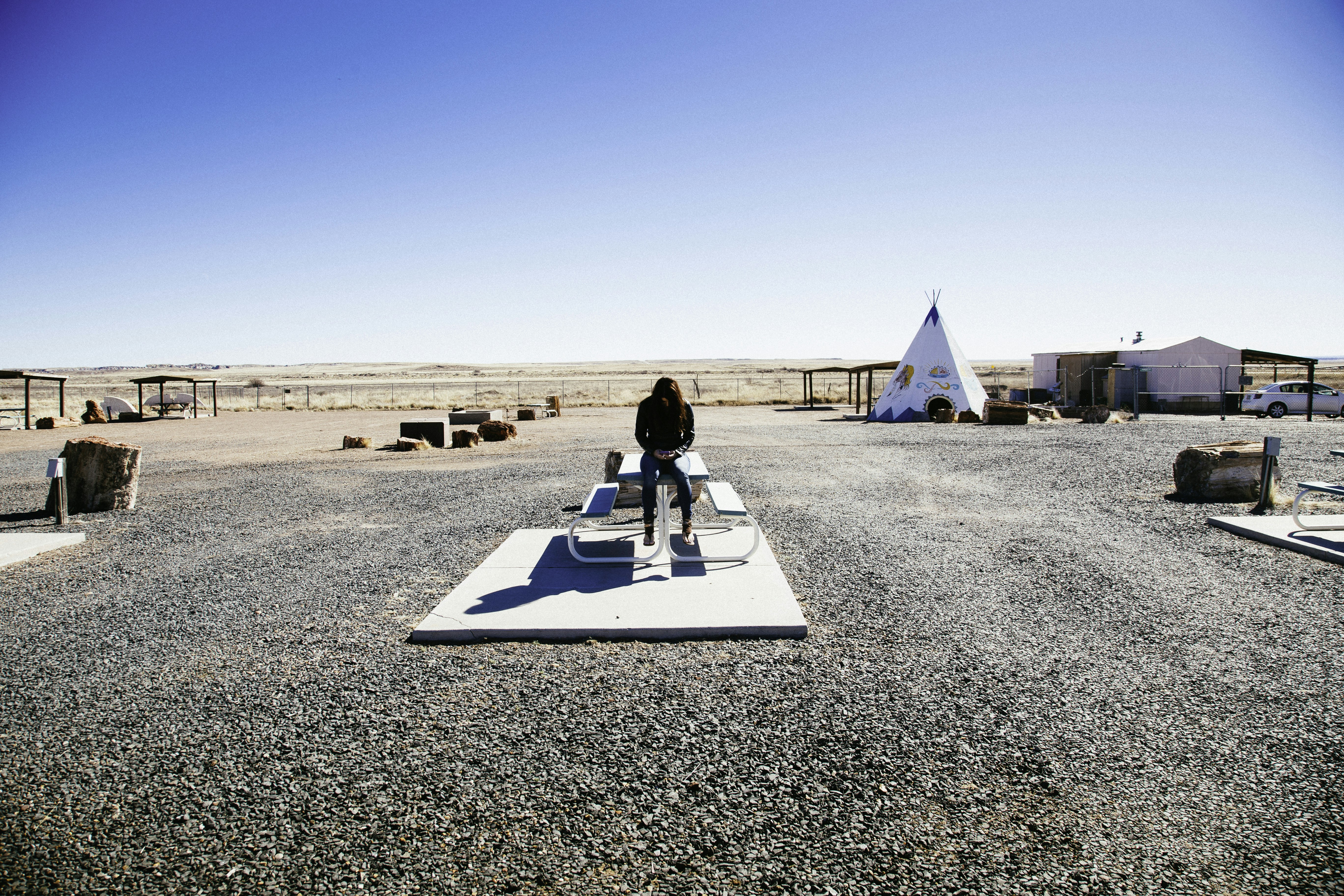 person sitting on the picnic table during daytime