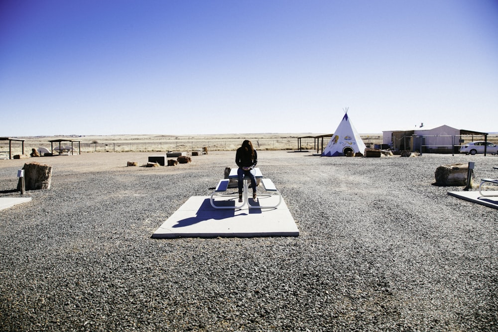 person sitting on the picnic table during daytime