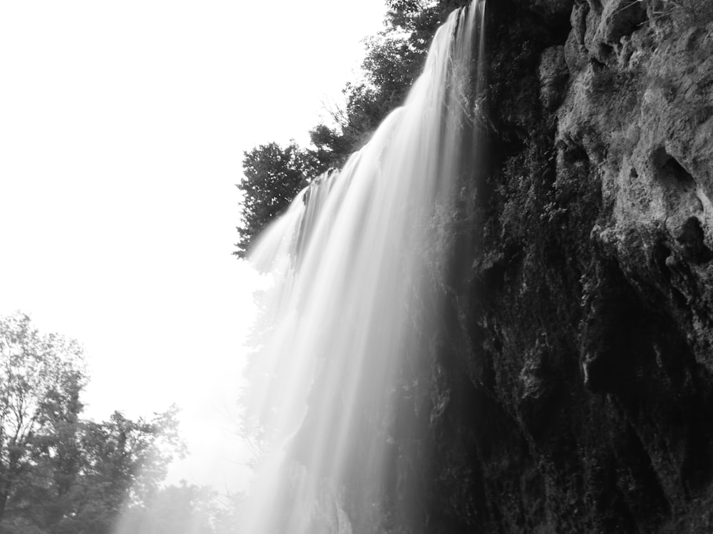 grayscale photo of waterfalls during daytime