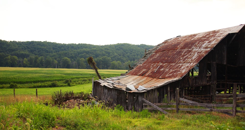 brown wooden house on green grass field during daytime