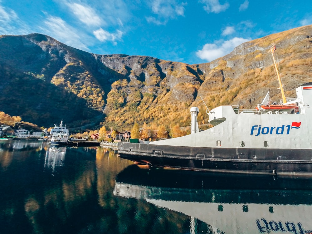 Ffjord1 ship on body of water near ships and mountains