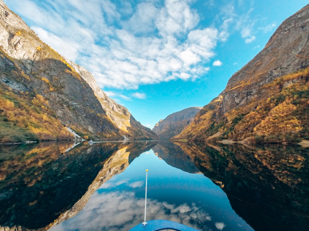 body of water surrounded by rocky mountains