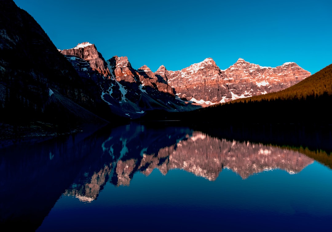 rocky mountain near the body of water photography