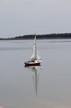 A beautiful classic sailing boat on calm waters.