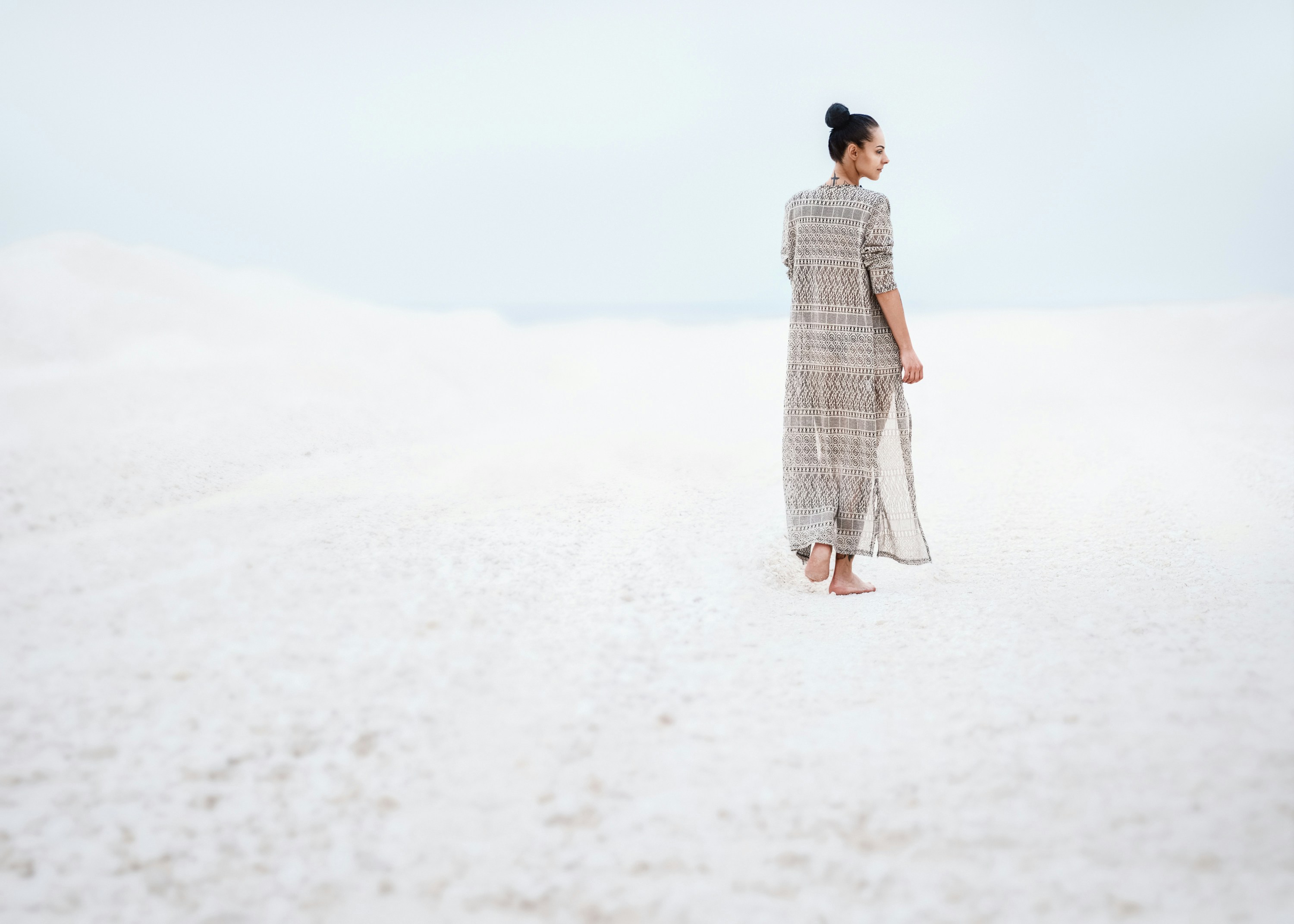 woman in gray dress walking on sand, White sun