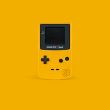 white and black Nintendo Game Boy Color on yellow surface