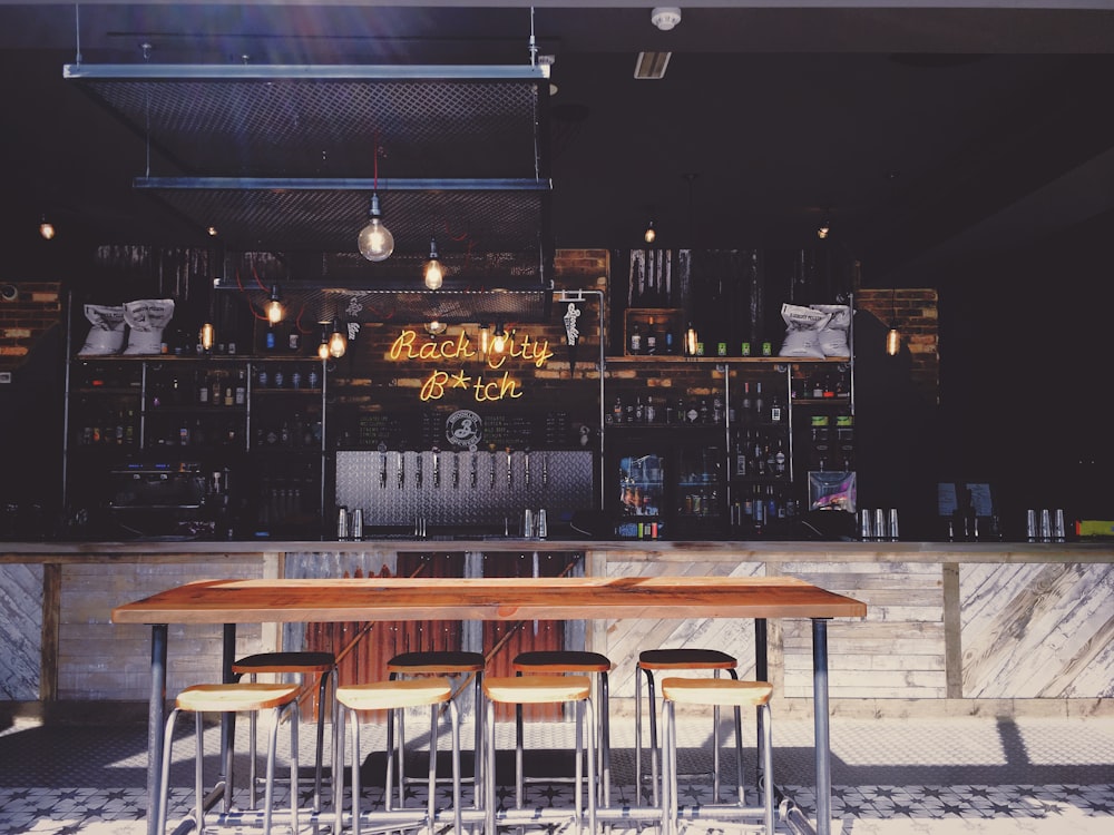 brown bar counter with stools