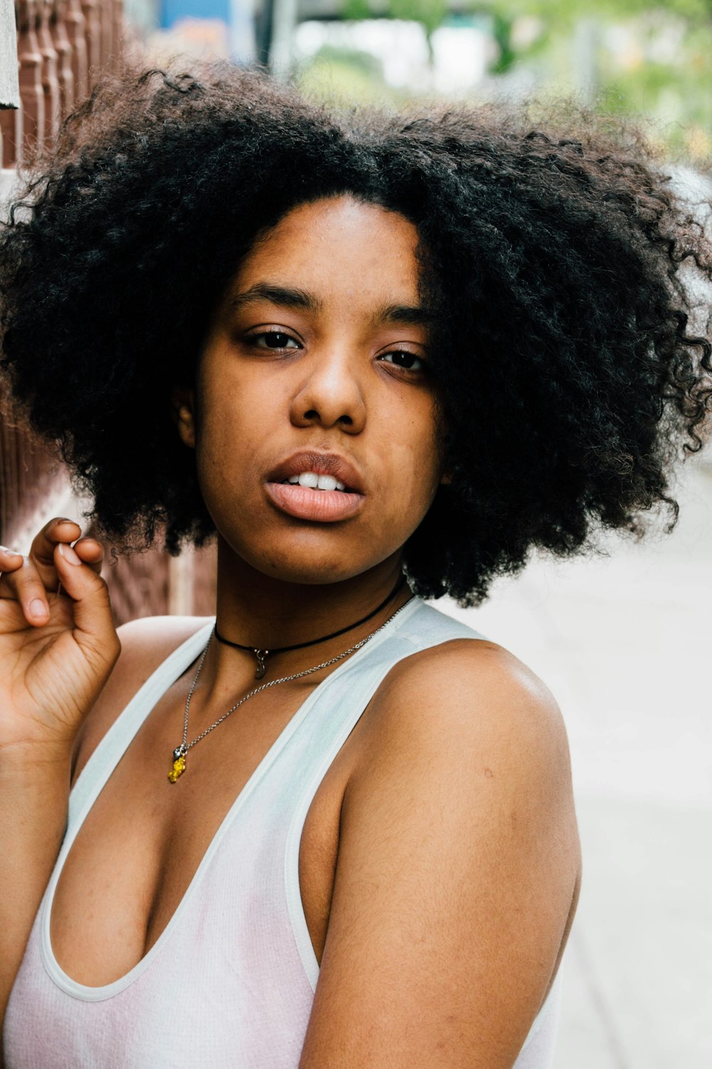 Mujer con top blanco sin mangas con cuello redondo