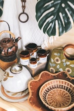 ceramic container near basket and bowl beside bag
