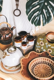 ceramic container near basket and bowl beside bag