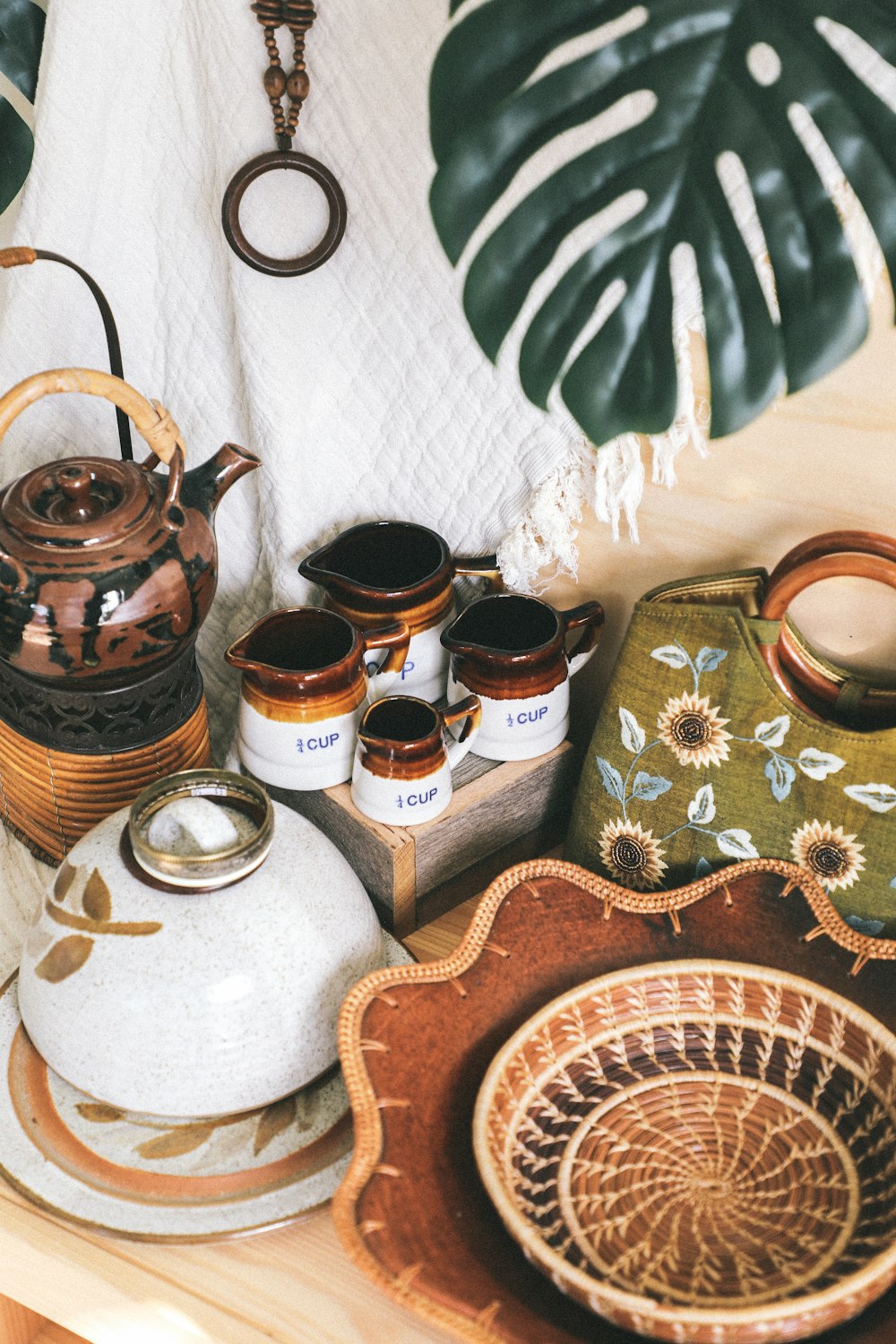 ceramic container near basket and bowl beside bag