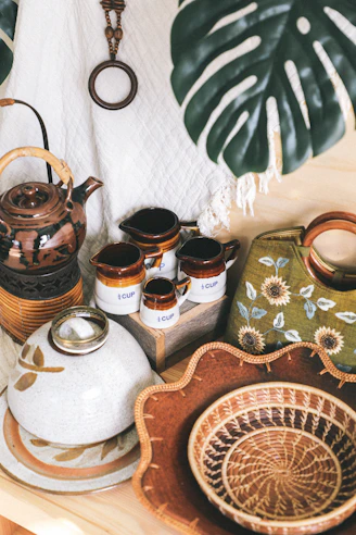 ceramic container near basket and bowl beside bag