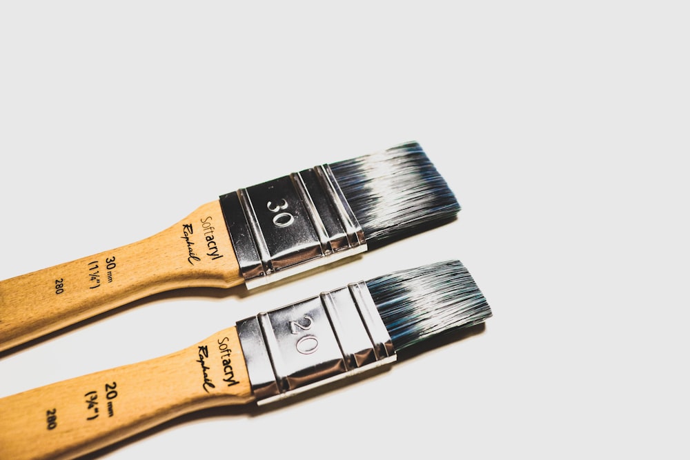 two brown paint brushes
