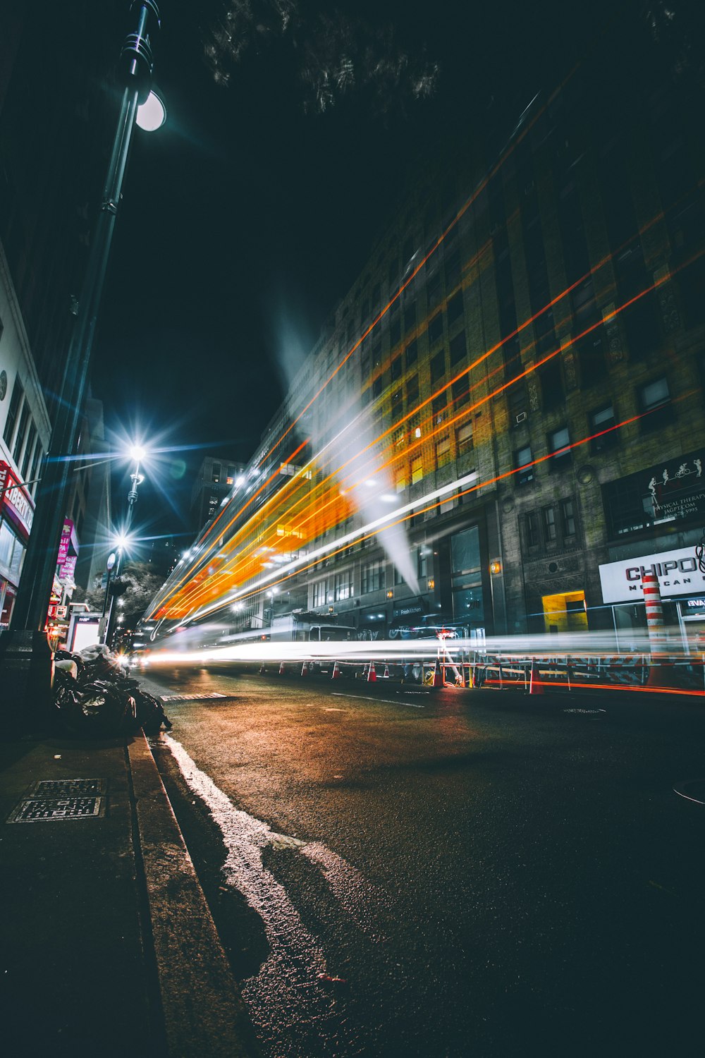 time lapse photography of street surrounded by high-rise buildings