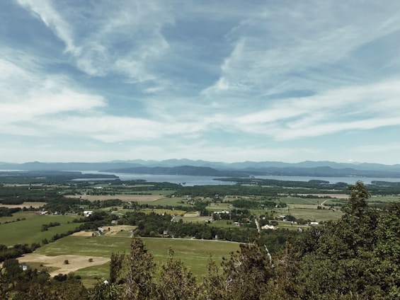 Scenic view of fertile farmland and peaceful lakes in the Warmia and Mazury region at sunrise.