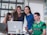 A group of diverse customers smiling and sharing positive feedback in a modern office.