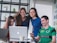 A diverse group of students happily engaging in an online tutoring session together.