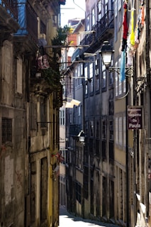 A grainy analog photo of an old European alley bathed in soft morning light.