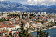 Panoramic view of a coastal city with a blend of modern and old architecture.