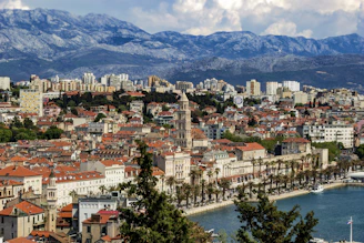 Panoramic view of a coastal city with a blend of modern and old architecture.