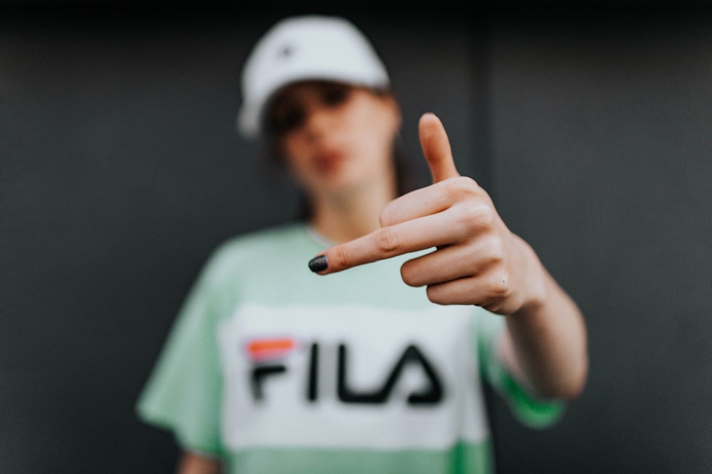 selective focus photo of woman raising middle finger