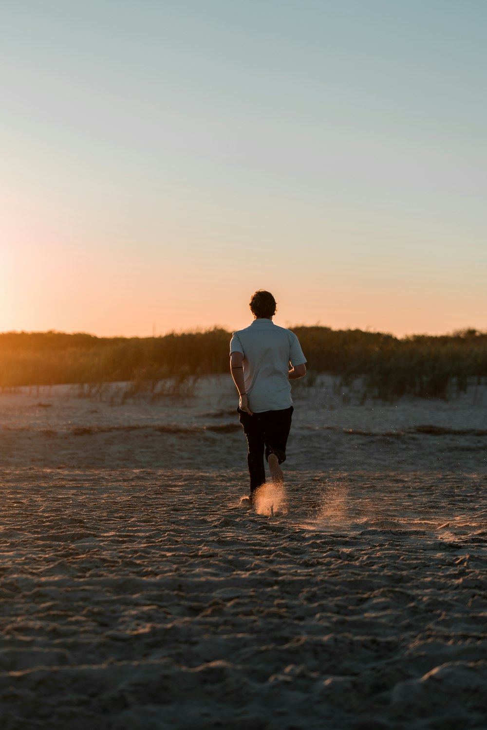 person walking on the sand