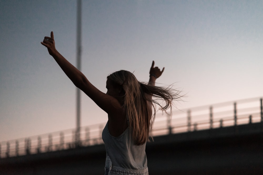 woman raising his hands during daytime