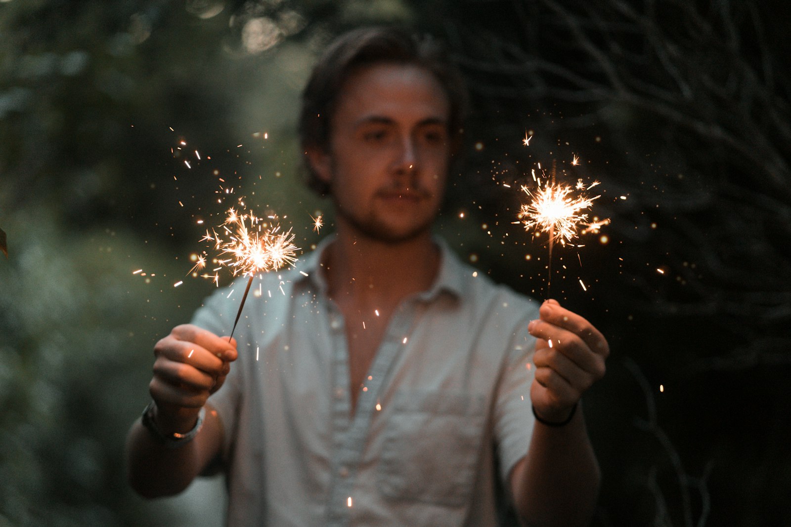 Sony a7 + Sony FE 85mm F1.8 sample photo. Man holding sparklers photography