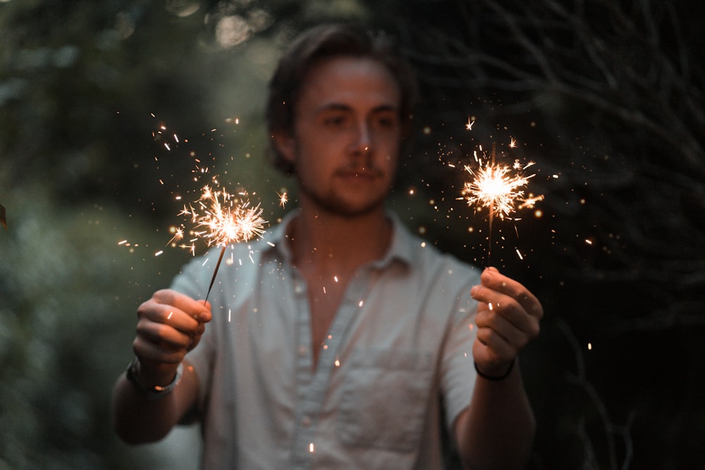 man holding sparklers