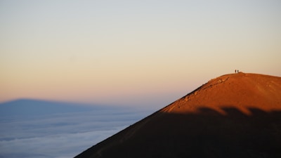 Mountain peak with sunrise symbolizing reaching the business summit.