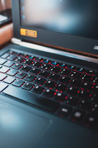 A close-up of a high-performance gaming laptop with colorful backlit keyboard.