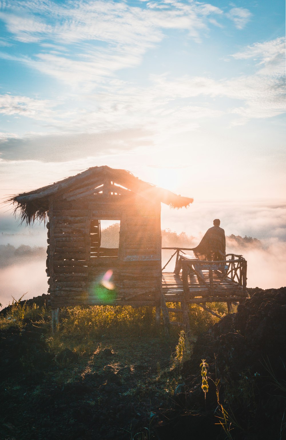 silhouette of standing person near house at daytime