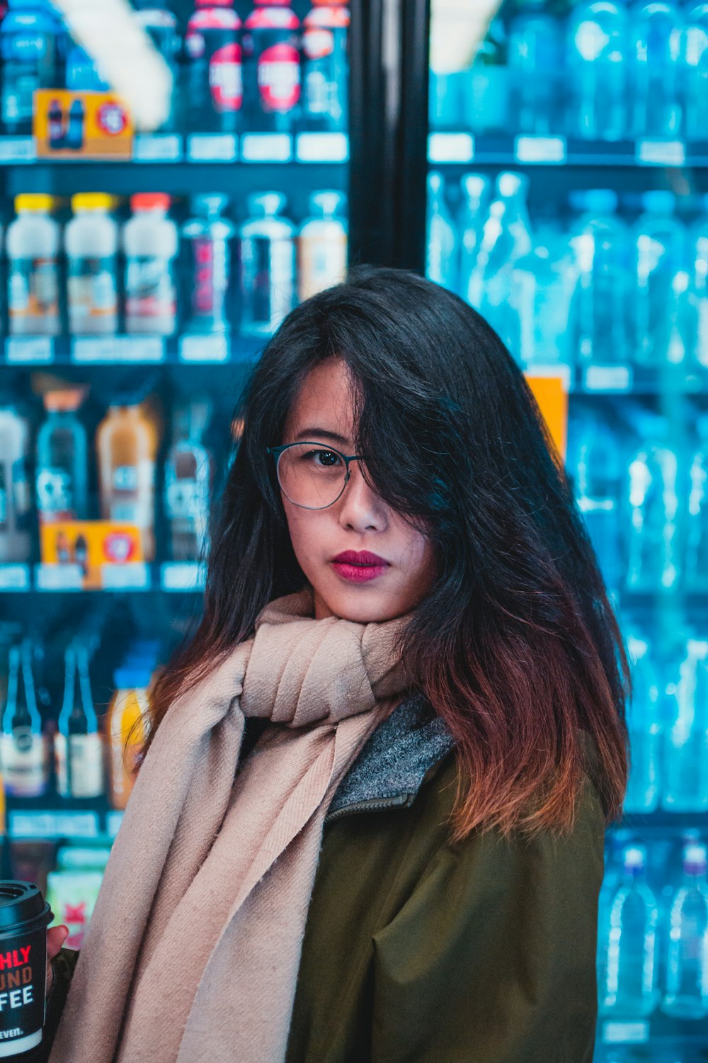 woman wearing brown scarf and green jacket