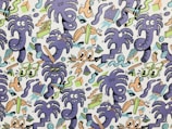 A vibrant and playful cartoon pattern features a series of whimsical purple creatures with various expressions, surrounded by abstract shapes. The design incorporates elements like eyes, squiggly lines, and geometric forms in a chaotic arrangement, giving a sense of movement and liveliness.