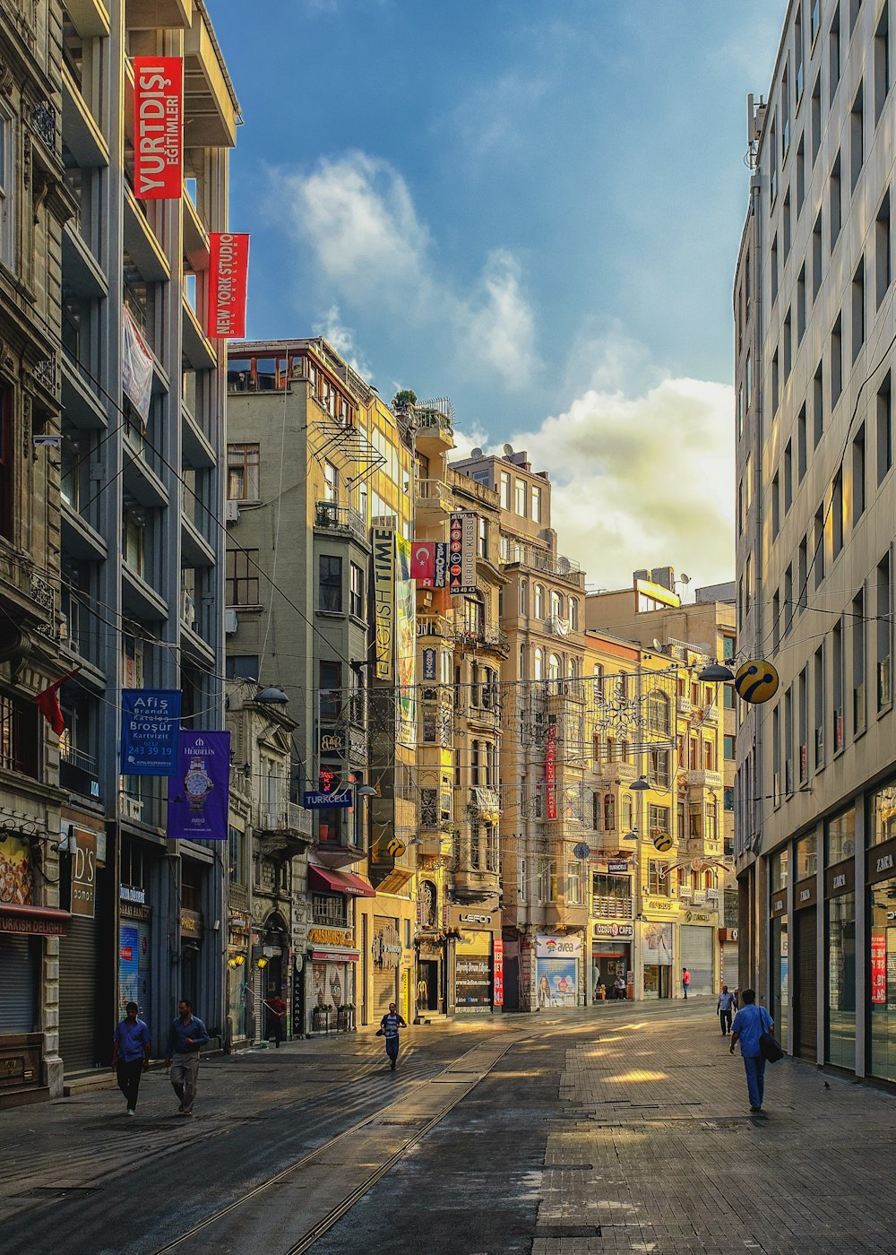 people walking on alley surrounded with buildings artwork