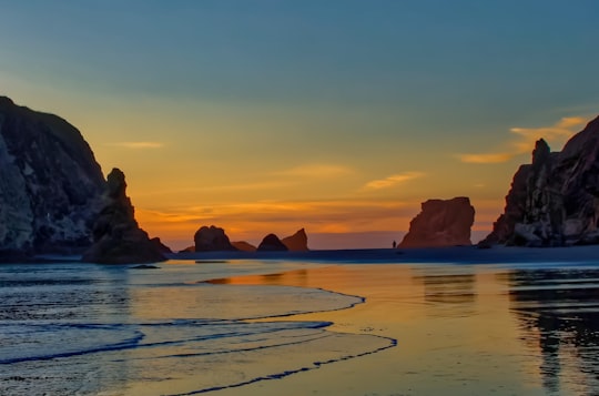 landscape photo of body of water near gray mountains in Bandon United States