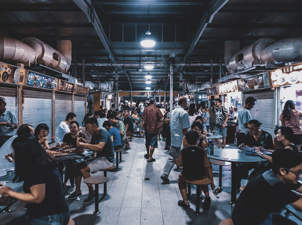 group of people sitting in front of tables