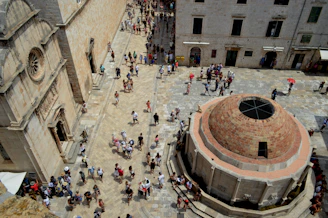 A knowledgeable guide sharing stories with a small group in a historic city square.