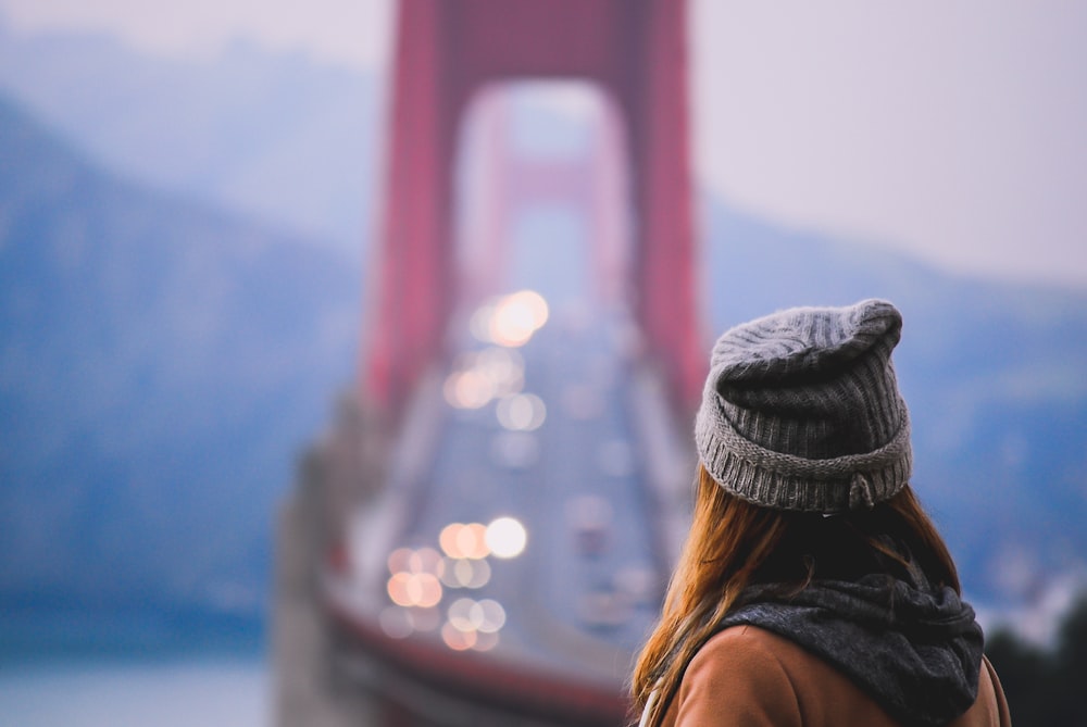 shallow focus photography of person wearing gray knit hat