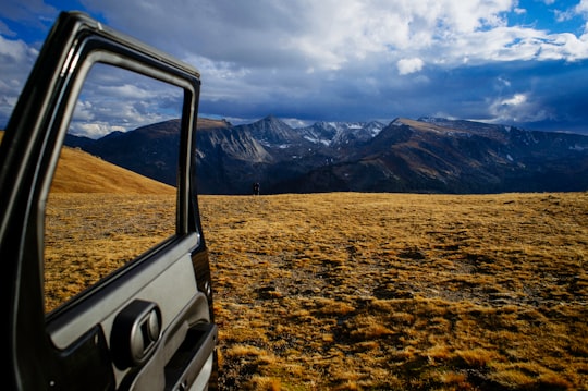 opened vehicle door with mountain alps view in Estes Park United States