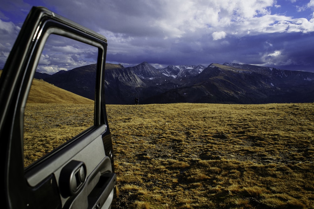 opened vehicle door with mountain alps view