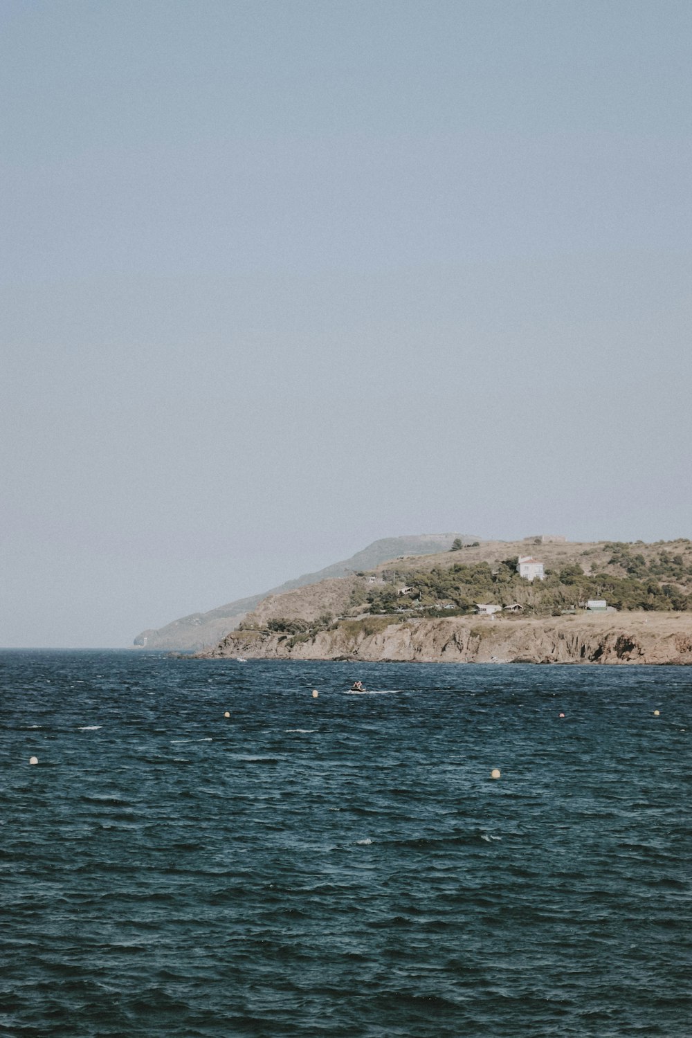 body of water under gray sky