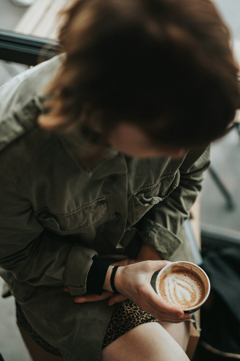 person holding cup of coffee latte