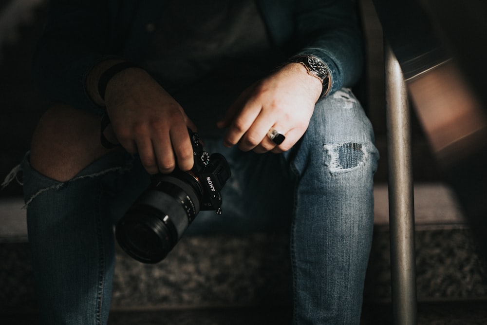 person holding black DSLR camera