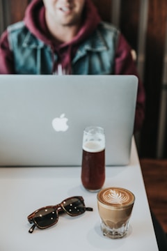 A happy customer wearing a digitech85 hoodie while using a laptop.