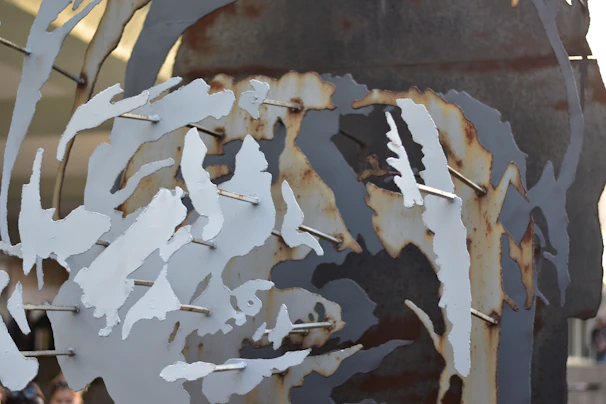 Close-up of a metal art piece showcasing intricate anime-inspired characters with bold colors and sharp details.