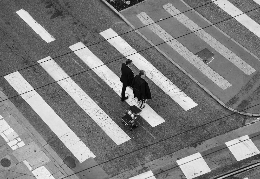 aerial photography of men walking on pedestrian lane