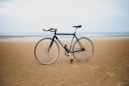 black road bike on sand